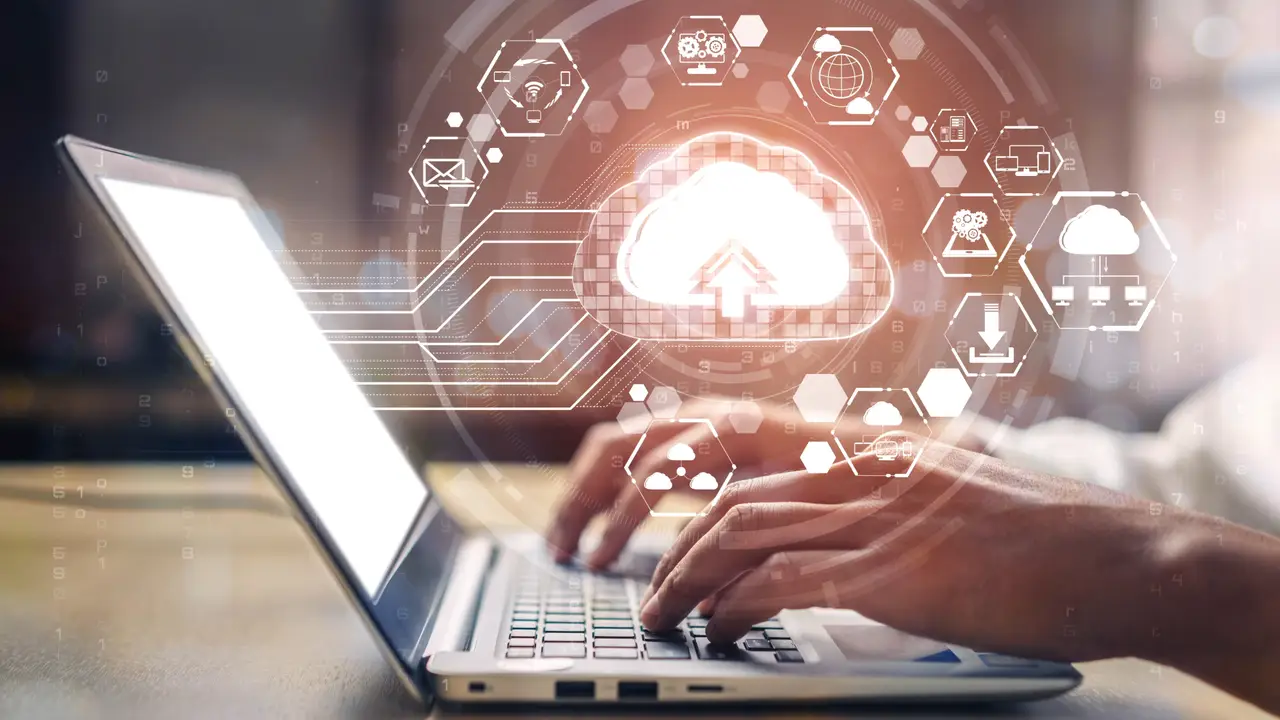 Laptop with connected-device and cloud network icons representing a smart building IoT platform