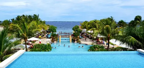 Lagoon pool and palm gardens leading to the sea at Crimson Mactan