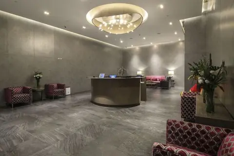Residential lobby and reception desk beneath a circular chandelier at Eton Tower, Makati