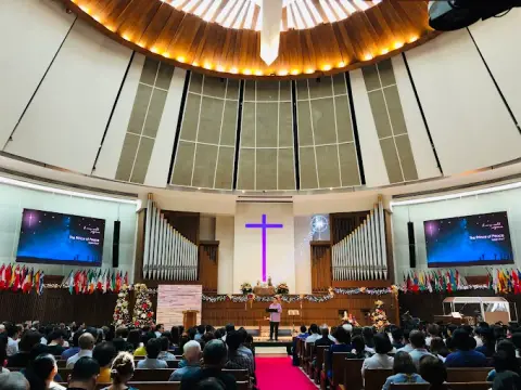Congregation facing the sanctuary, pipe organ and twin projection screens at Full Gospel Church, Makati