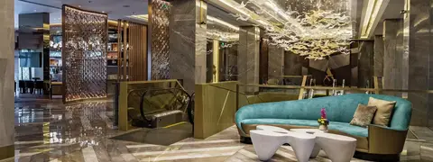 Hotel lobby lounge with sculptural chandelier and marble finishes at Hilton Manila