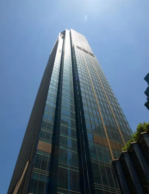 Upward view of the Metrobank Center Grand Hyatt tower façade against a clear sky