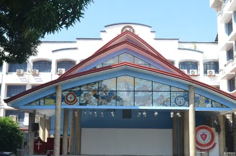 Entrance gable with mosaic artwork at the Pasig Catholic school auditorium
