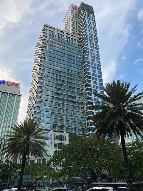 Philam Life office tower in Makati framed by palm trees