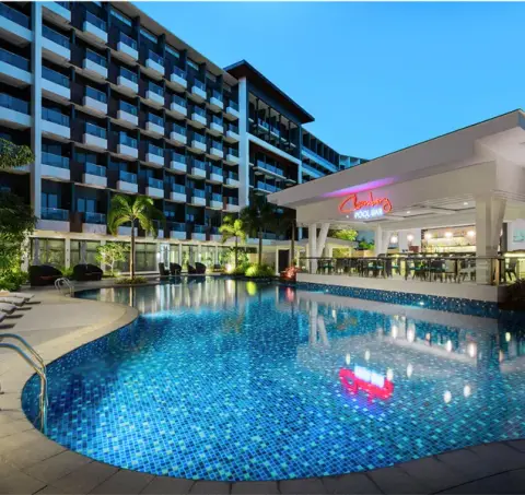 Resort pool framed by guest room wings at Savoy Hotel Boracay
