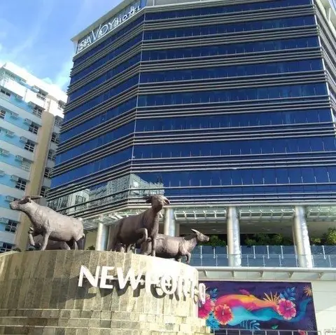 Savoy Hotel tower façade above the Newport City entrance sculpture in Pasay