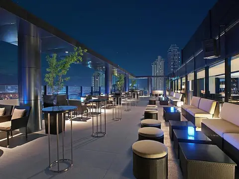Open-air rooftop lounge at night overlooking Bonifacio Global City, Seda Hotel BGC