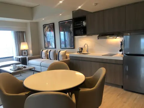 Suite living area with kitchen and dining table at Seda Hotel Glorietta, Makati