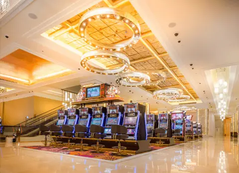 Gaming floor beneath ornate chandeliers at Winford Resort & Casino, Manila